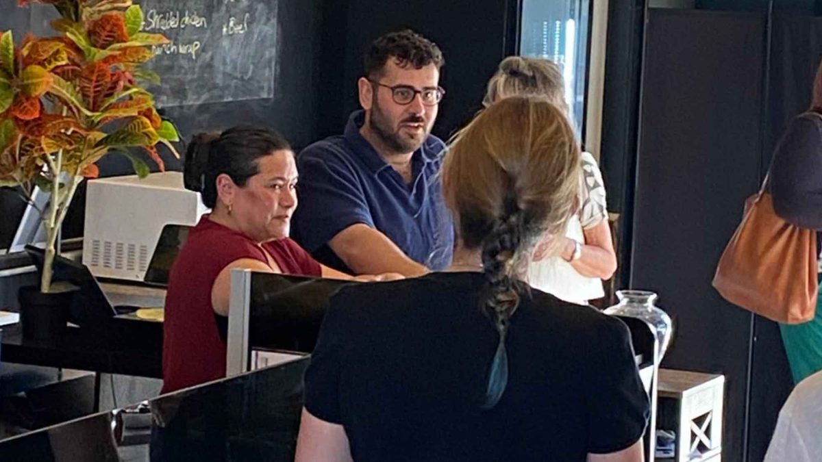 Business owners talking over the counter at a local supper club