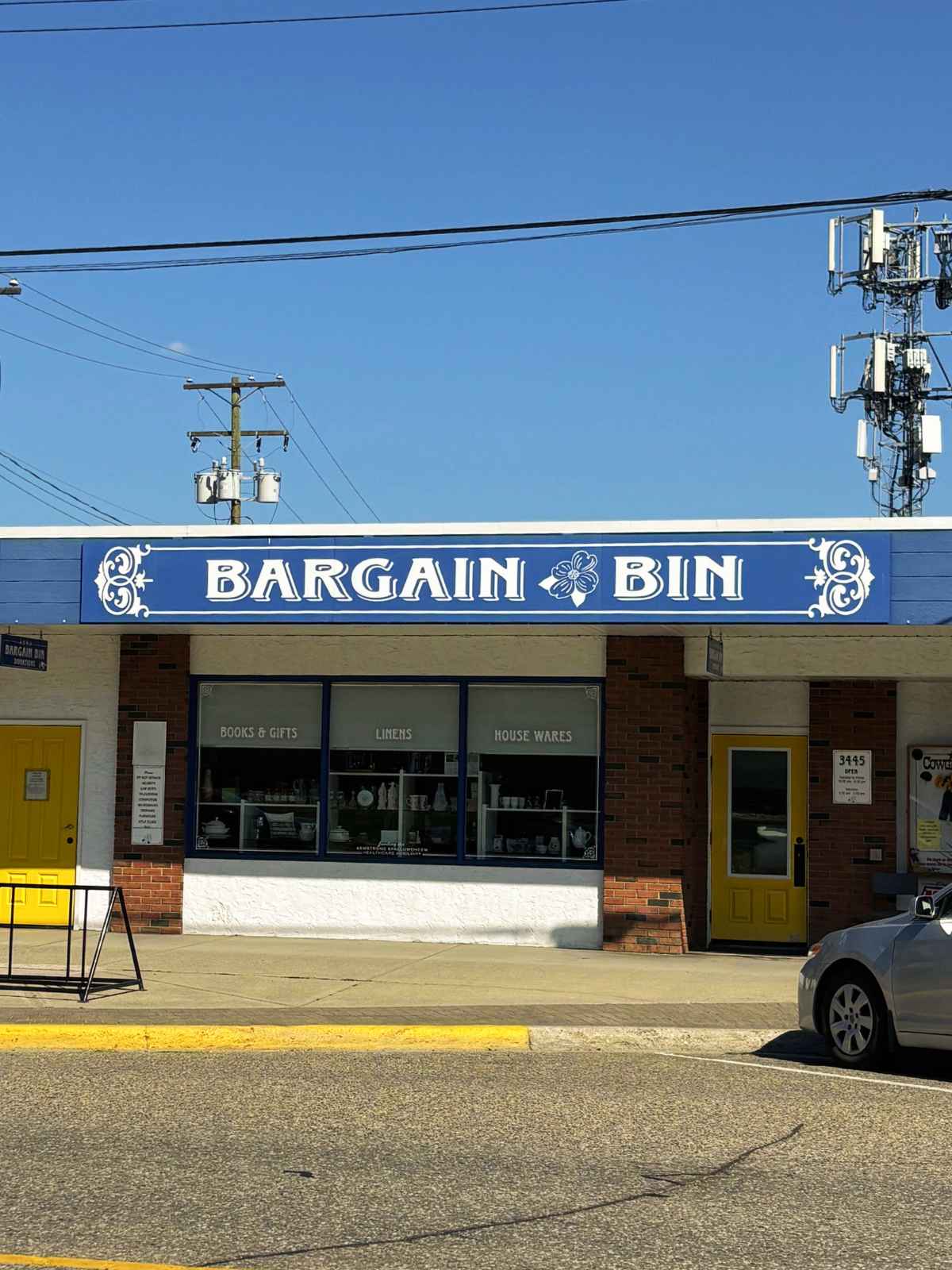 The Bargain Bin shopfront and yellow door at 3445 Pleasant Valley Road