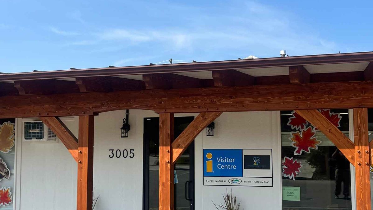 The Armstrong Spallumcheen Visitor Centre at 3005 Wood Avenue, with the Visitor Centre sign under the entrance pergola