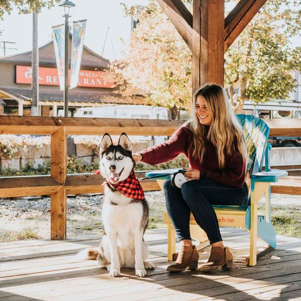 A resident and her dog on a downtown Armstrong porch in fall