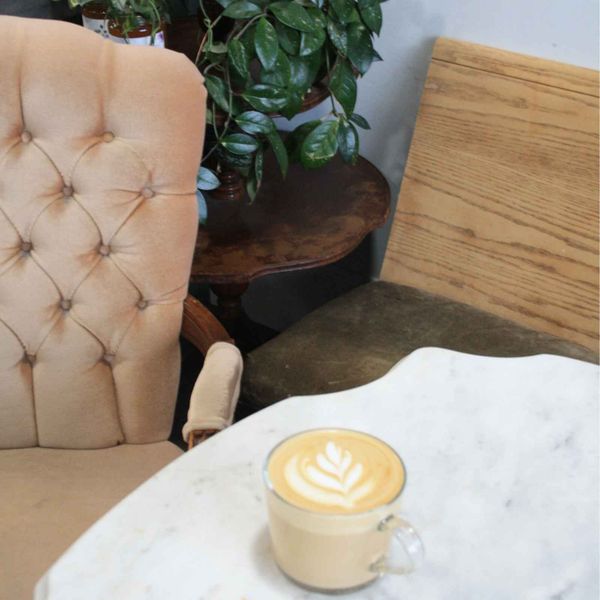 A latte on a marble table in an Armstrong coffee shop