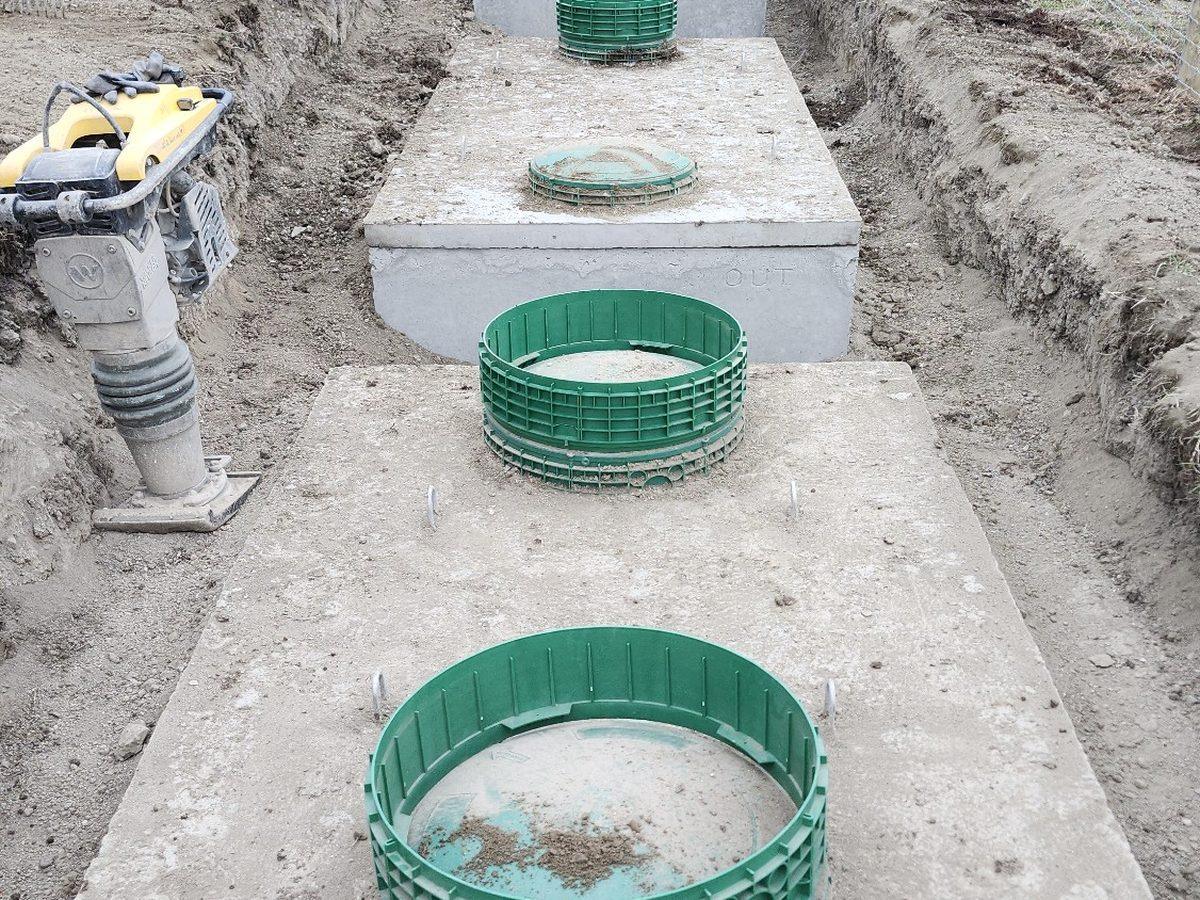 Septic tanks with green access risers during installation by North Valley Contracting